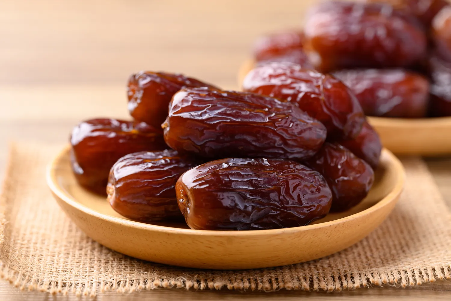 Bowl of dates on a burlap surface
