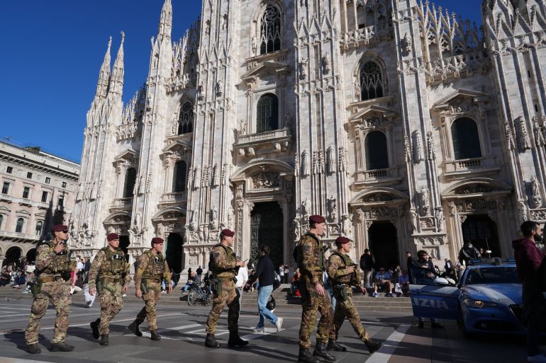 Italian army paratroopers patrol the area around Milan's Duomo Cathedral, Italy, Saturday, Oct. 24, 2026, ahead of expected protests against the rising cost of living and deteriorating public services during one of several protests in Italy organized by groups across the political spectrum. (AP Photo/Antonio Calanni)